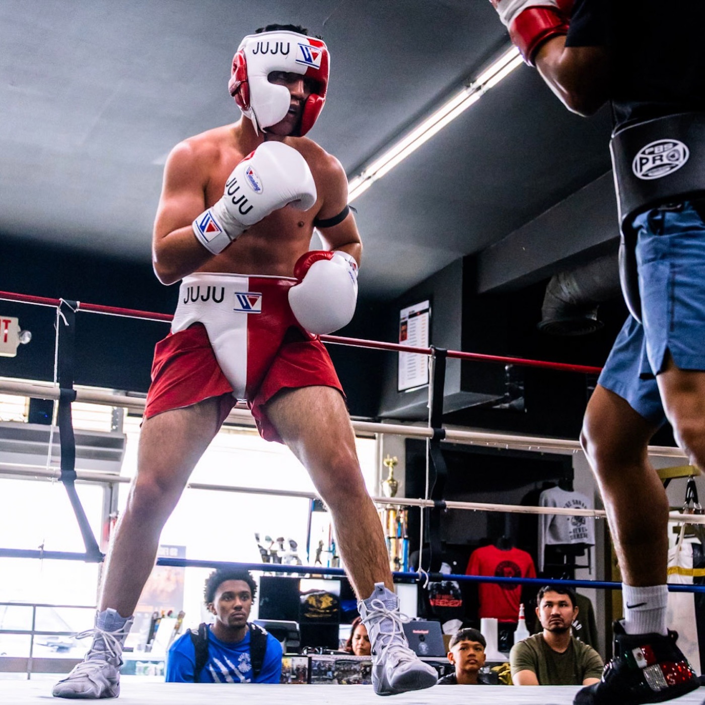 Julius Ballo sparring in headgear at Bomber Squad Academy