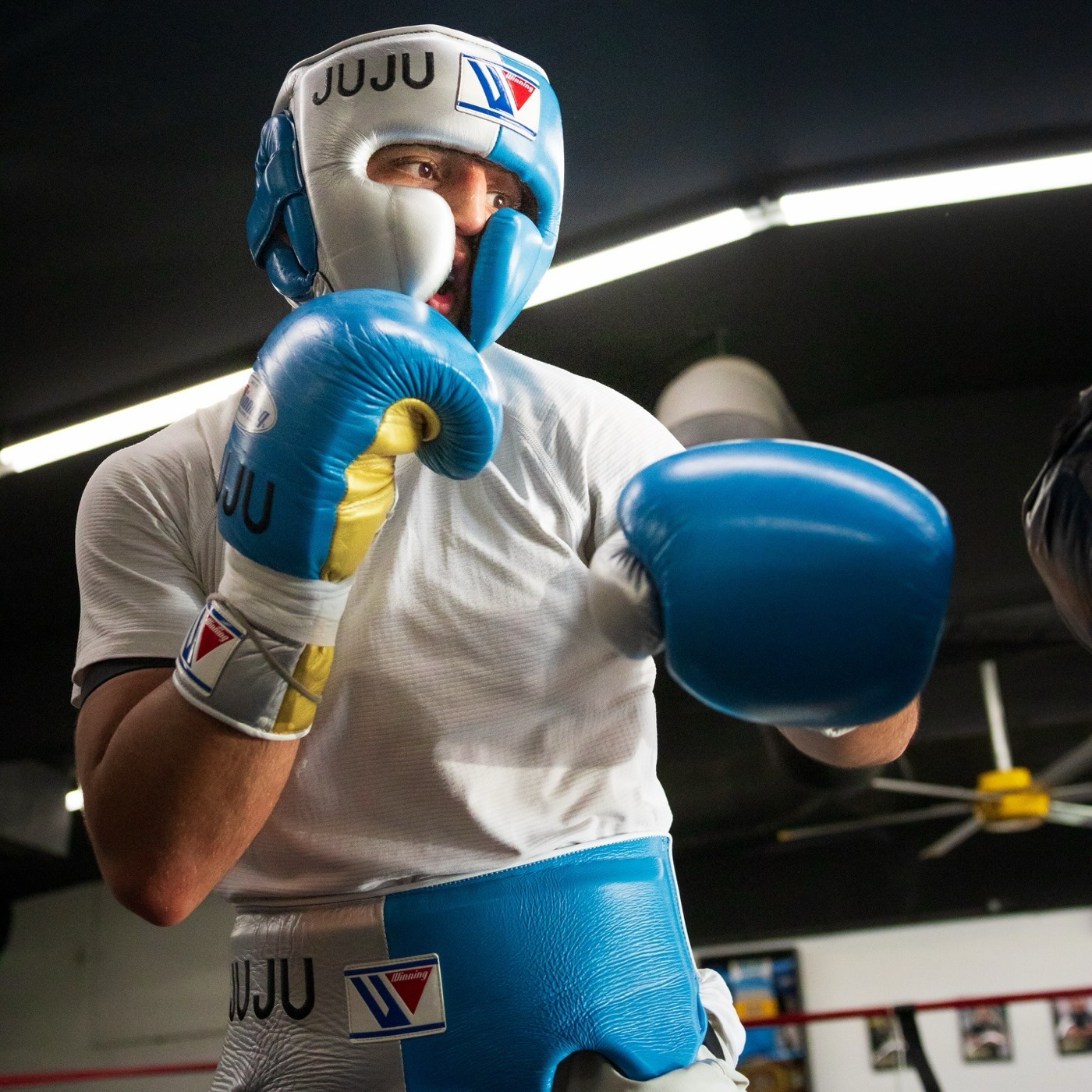 Julius Ballo working the mitts in blue gloves
